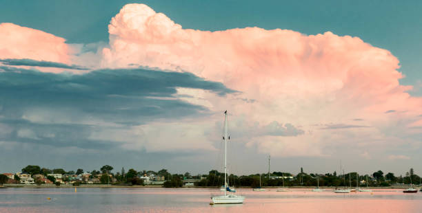Cumulus clouds over yacht pink hues