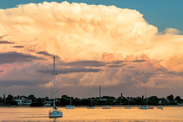 istock Cumulus clouds at sunset over yachts 860650502