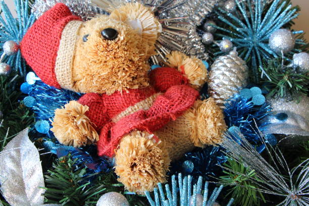 istock Teddy bear, Christmas balls and tinsel on a Christmas wreath 860654228