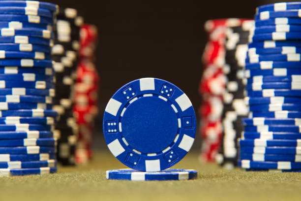 istock Closeup of poker chips on red felt card table surface 860664016