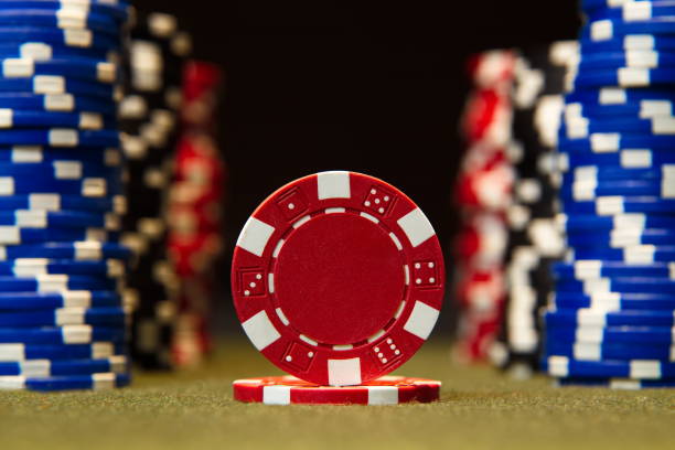 istock Closeup of poker chips on red felt card table surface 860664018