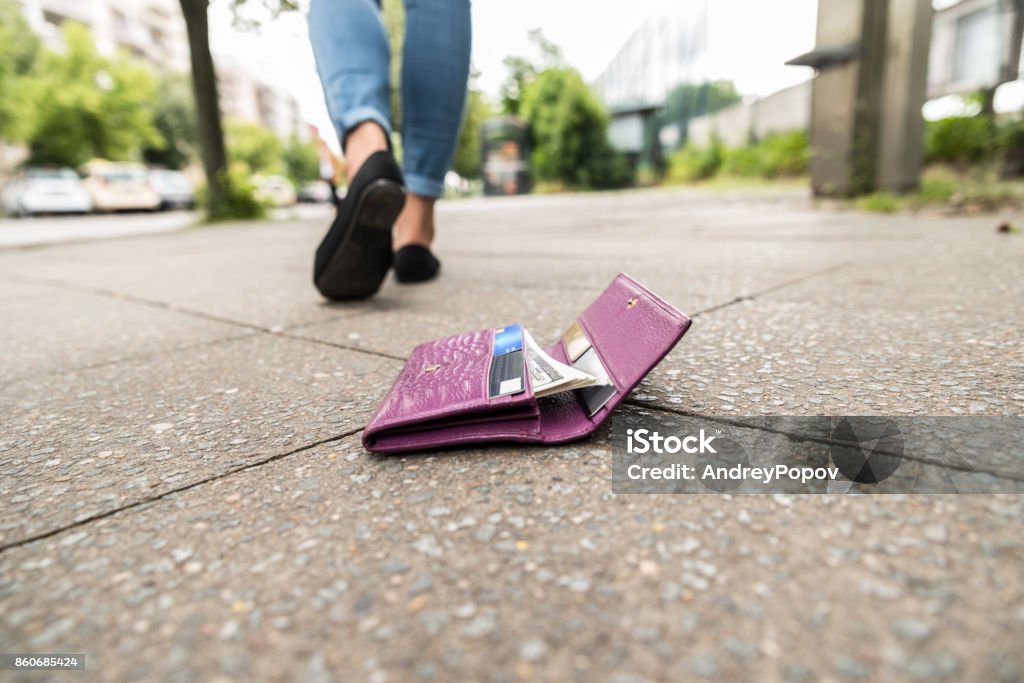 Close-up Of Woman Losing His Wallet Woman Walking After Losing His Wallet On Street Lost Stock Photo