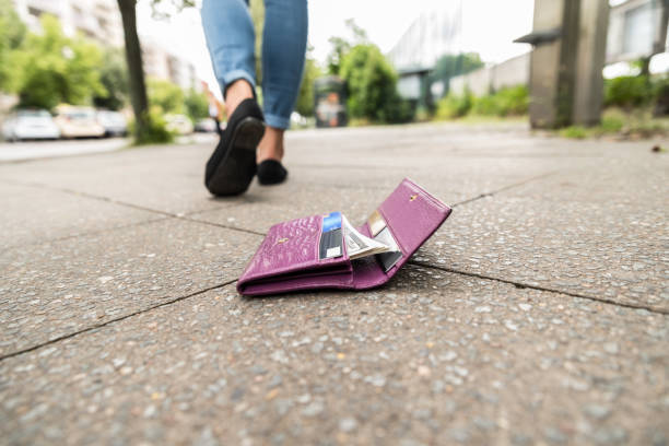Close-up Of Woman Losing His Wallet Woman Walking After Losing His Wallet On Street lost stock pictures, royalty-free photos & images