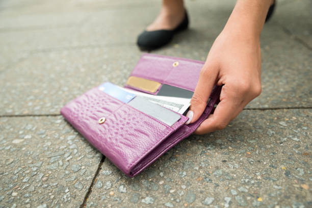 istock Woman Picking Up Fallen Wallet 860685426