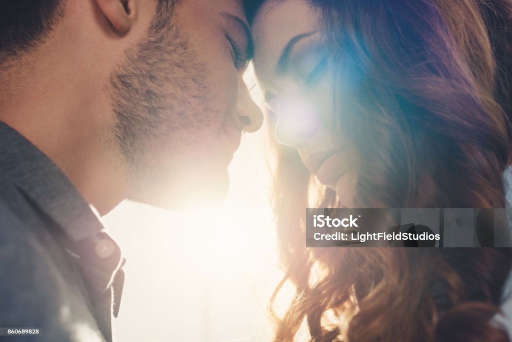 sensual couple in love close up view of sensual couple in love standing head to head Face To Face Stock Photo