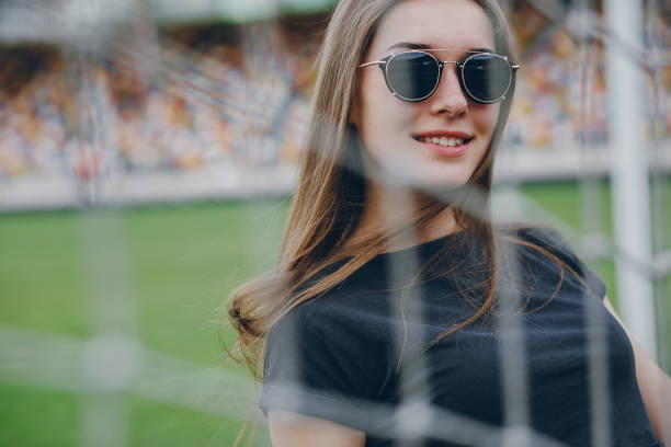 istock girl standing next to a net 860696220