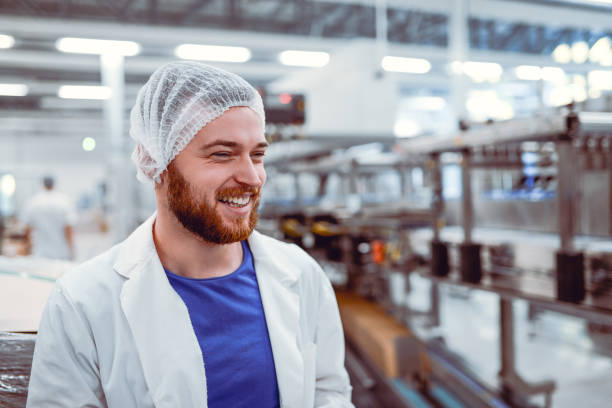 Young Smiling Scientist Posing in Modern Factory