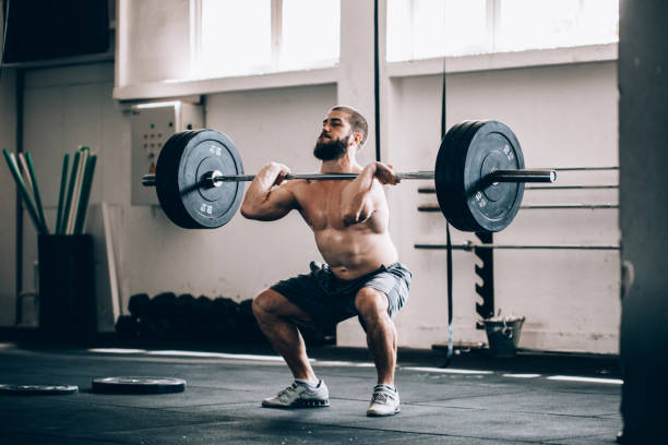istock Bodybuilder exercising with barbells in the gym 860704584
