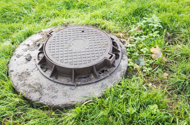istock Round sewer manhole cover in green grass 860707988