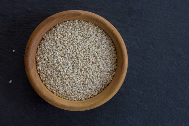 istock Sesam seeds in a little bowl wooden Natural light. Selective focus. 860725390