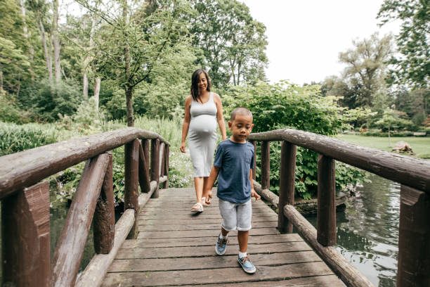 istock Mother and son walking by little bridge 860725460