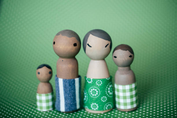 Adorable elderly figurines in winter attire holding a pink heart, symbolizing lifelong love and companionship.