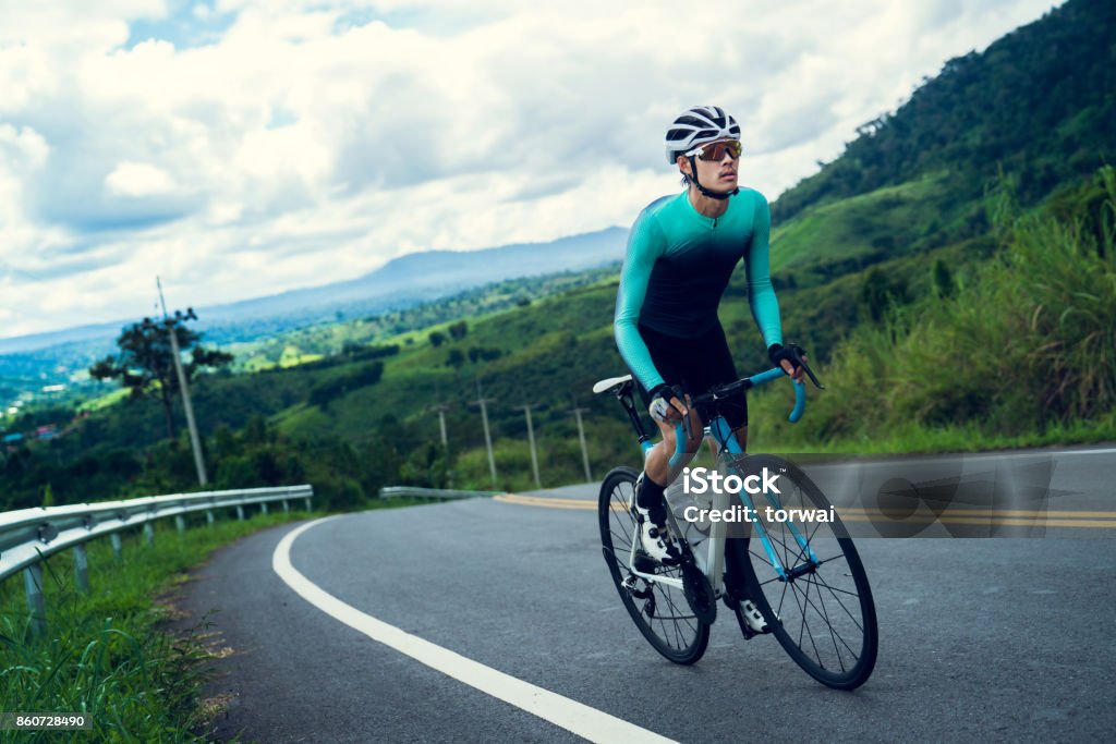 Cyclists are cycling, climbing up to the top. Cycling Stock Photo