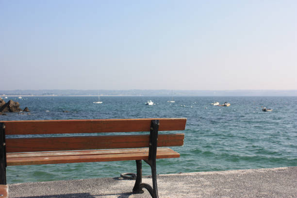 istock Public bench by the sea 860728500