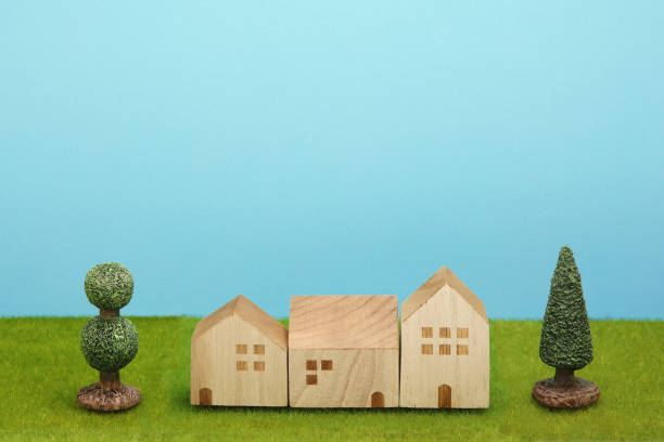 istock Houses on green grass over blue sky. 860728614