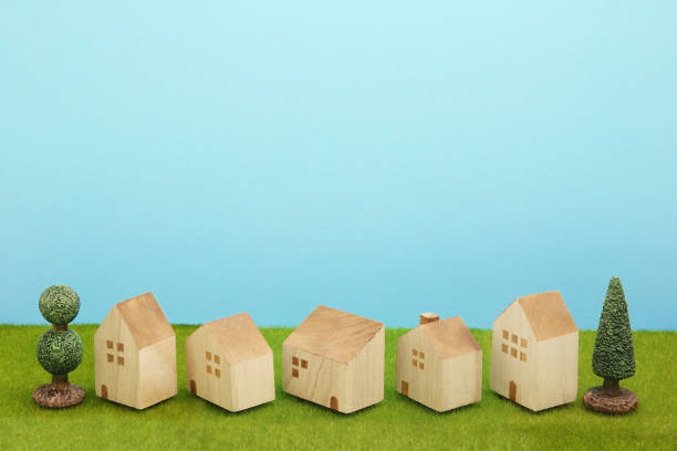 istock Houses on green grass over blue sky. 860728616