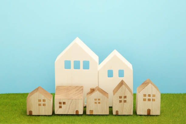 istock Houses on green grass over blue sky. 860728618