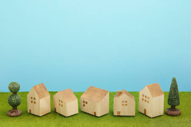 istock Houses on green grass over blue sky. 860728622