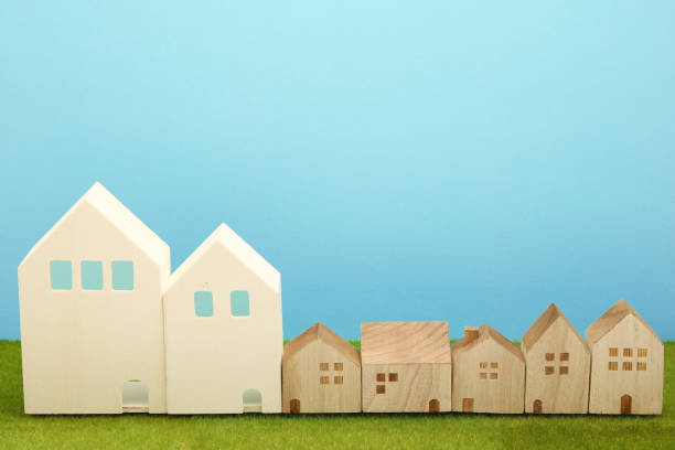 istock Houses on green grass over blue sky. 860728624