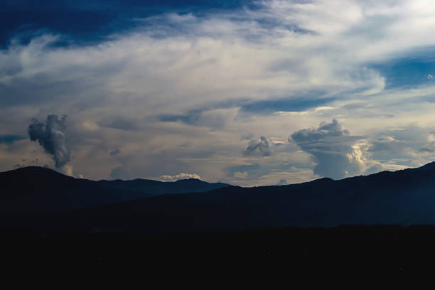 istock Evening sky with beautifully floating clouds and mountains. 860735474
