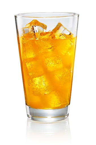 Glass of orange soda isolated on white background with clipping path