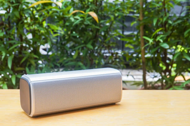 istock wireless bluetooth portable speaker on wooden table in home garden for relax 860739554