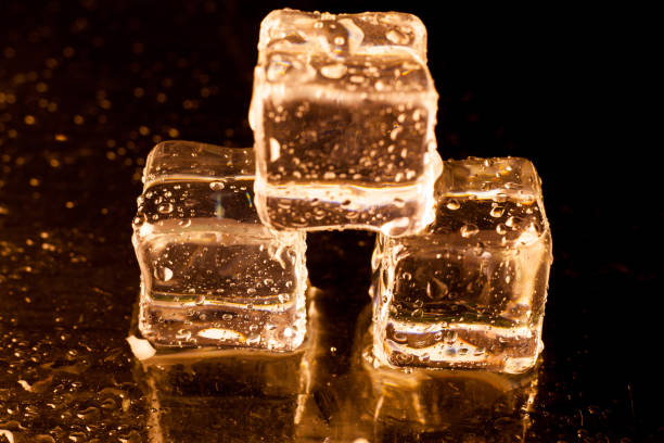 istock Gold ice cubes on black background. 860740092