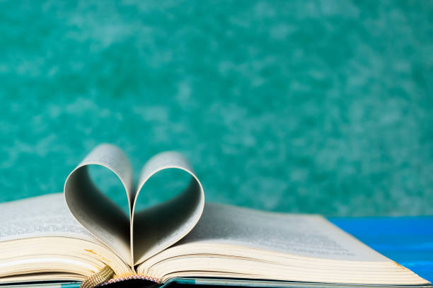 istock Closeup hardcover book isolated on green background. Selective focus. 860746240