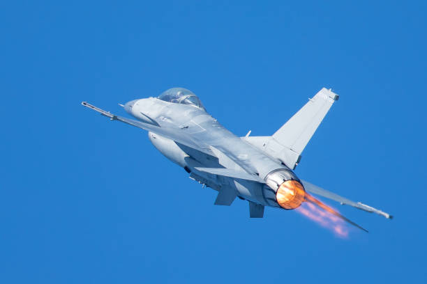 istock F-16 Fighting Falcon flying away, with afterburner on 860746524