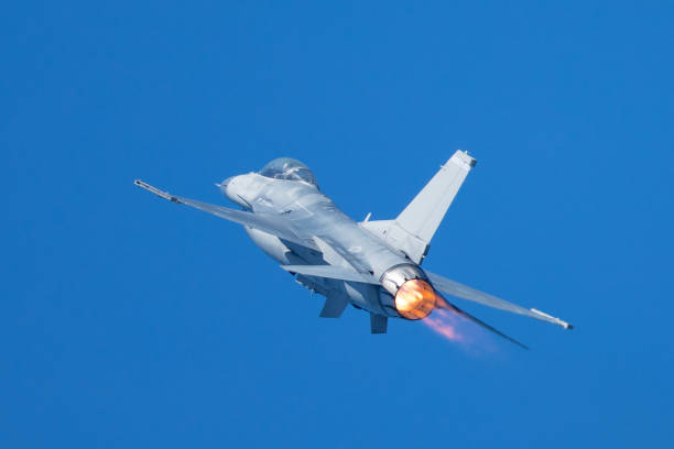 istock F-16 Fighting Falcon flying away, with afterburner on 860746530