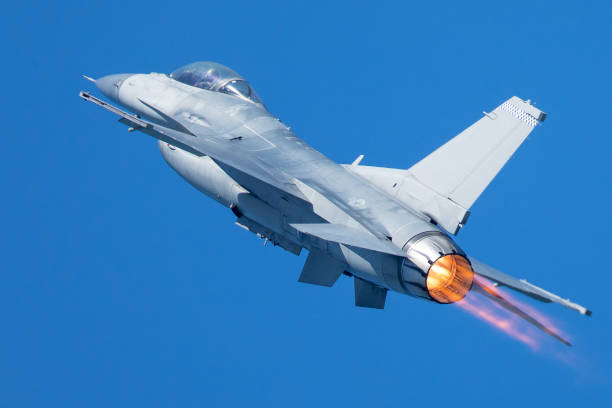 istock F-16 Fighting Falcon flying away, with afterburner on 860746540