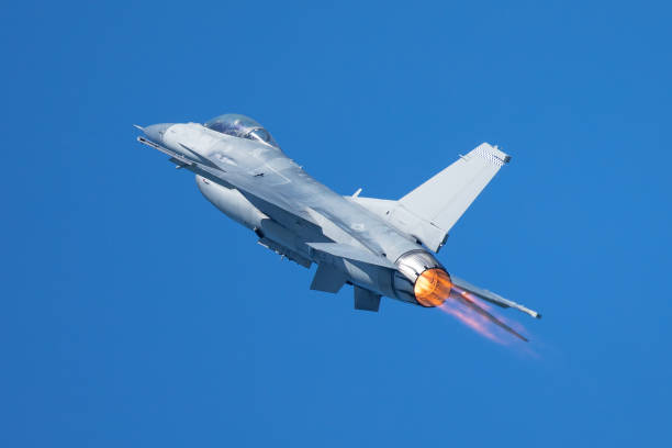 istock F-16 Fighting Falcon flying away, with afterburner on 860746552