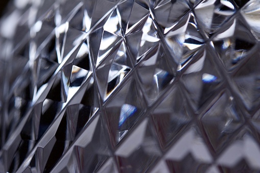 This abstract background features an artistic defocused macro view of beautiful hand cut lead crystal facets