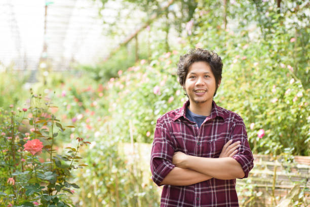 istock Asian man gardener standing in a garden 860746828