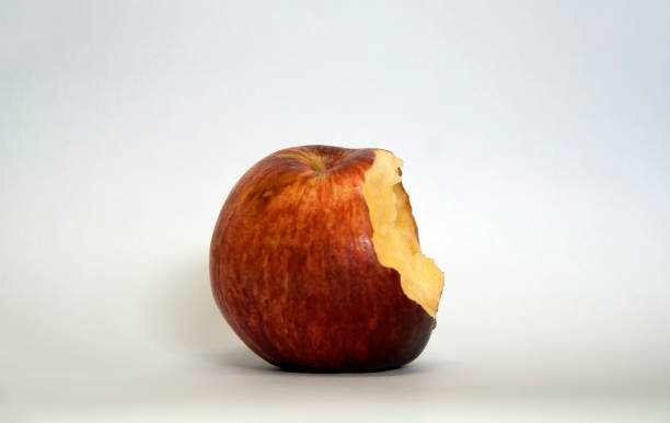 istock Red apple is bitten isolated on white background. 860753296