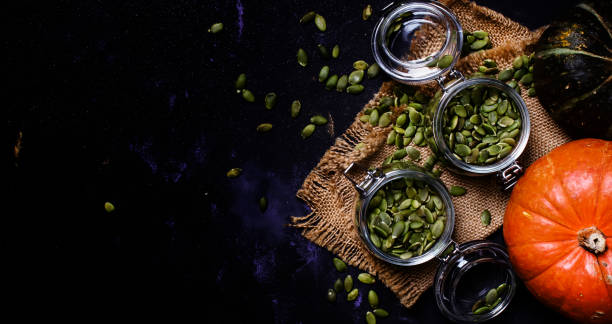 istock Raw pumpkin seeds in glass jar 860763976