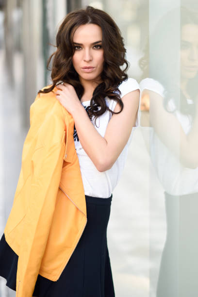 istock Young brunette woman smiling in urban background. 860767042