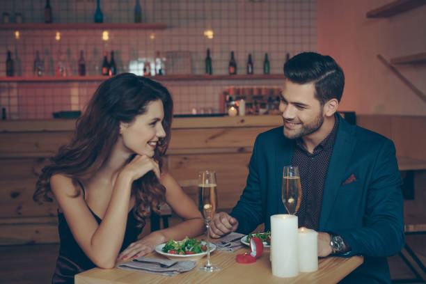 couple having romantic dinner young couple in love having romantic dinner together in restaurant together for yes stock pictures, royalty-free photos & images