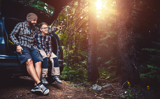 istock Father and son travelling by car 860767784