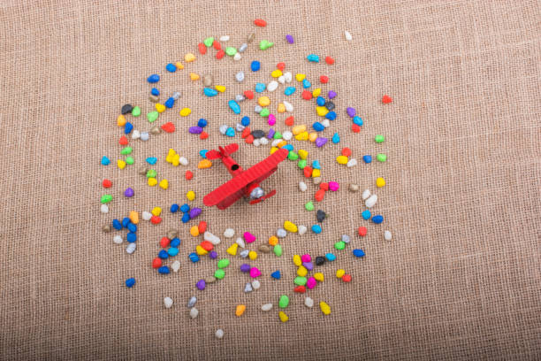 istock Airplane in hand amid colorful pebbles 860768012
