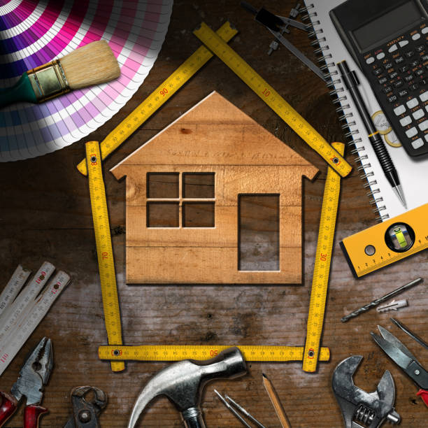 Work Tools and Model House - Home Improvement Home improvement concept - Wooden model house with work tools and a calculator on a wooden desk work tool nail wood construction stock pictures, royalty-free photos & images
