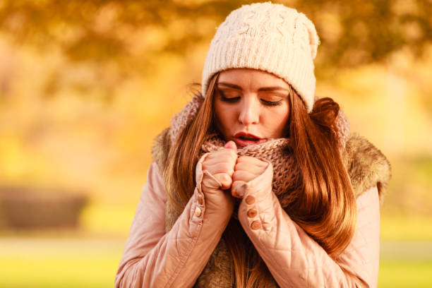 istock Woman walking in park feeling cold 860771378