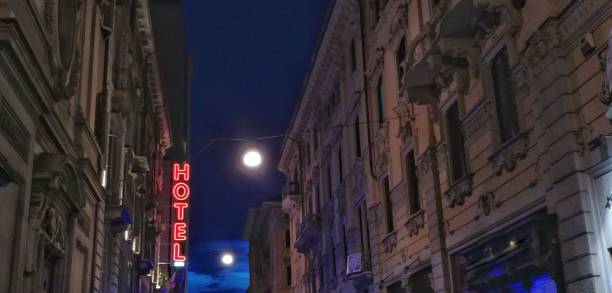 istock Hotel neon light sign in the street night 860774722