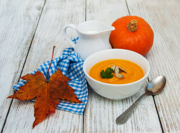 istock Pumpkin soup with fresh pumpkins 860774864