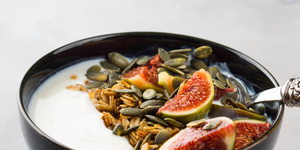 Healthy breakfast yogurt bowl with granola and fig