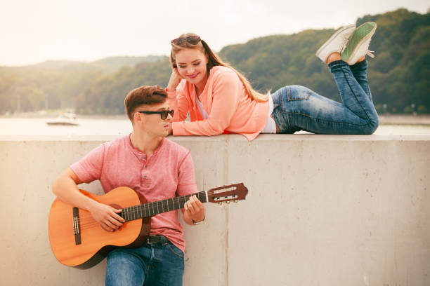 istock Happy couple with guitar outdoor 860778858