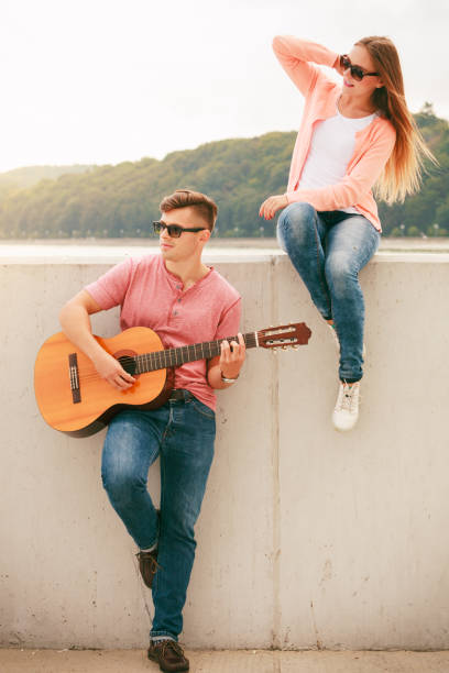 istock Happy couple with guitar outdoor 860779772