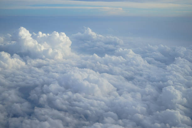 istock Shades of light blue color sky and constantly change floating white cloudscape view from airplane window 860783206