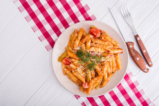 istock delicious penne pasta on wood white table 860785840