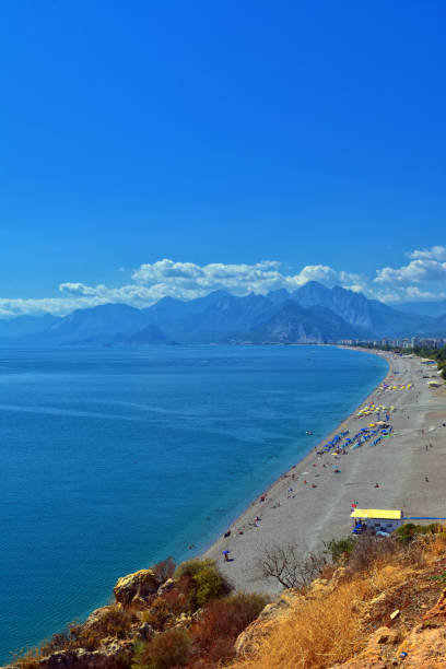 istock Panoramic view on Antalya beach, mountains and Mediterranean Sea from a ciff. Antalya, Turkey 860794528